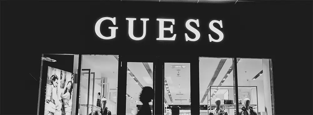 GUESS storefront at night