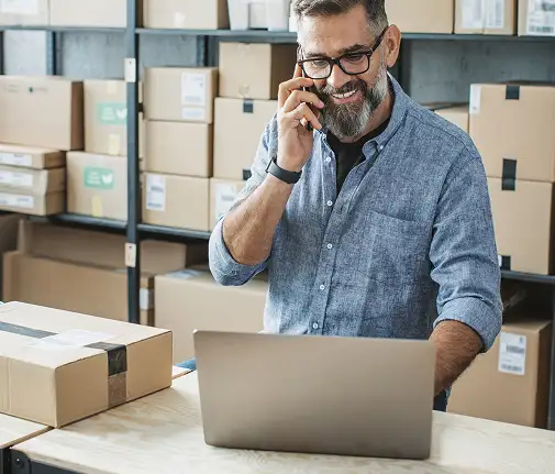 man on phone in warehouse